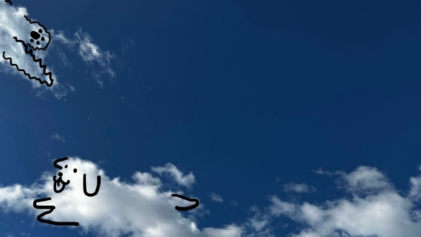 A dog imagined in the clouds against a clear blue sky